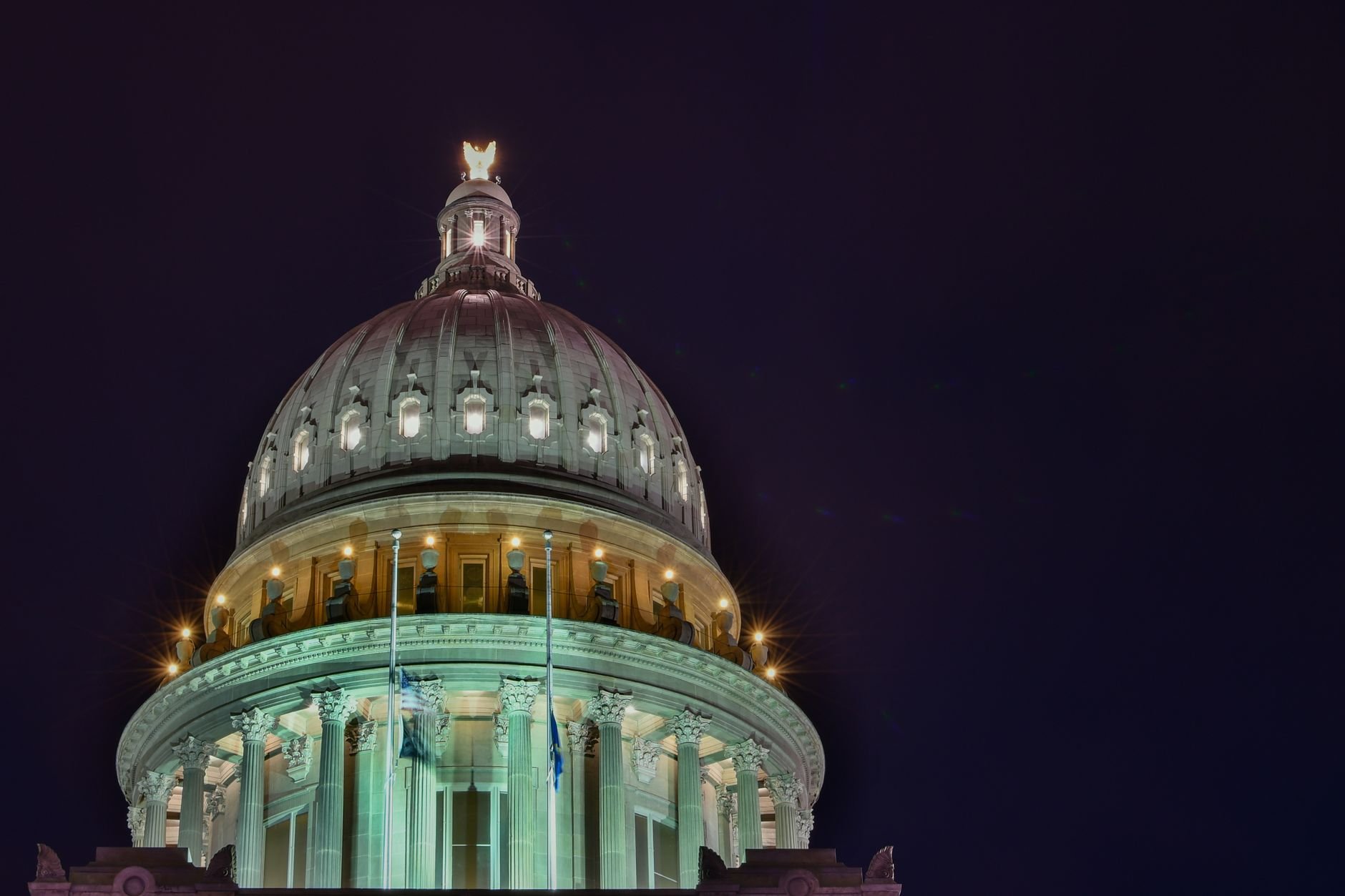 Illuminated capitol building dome against the night sky